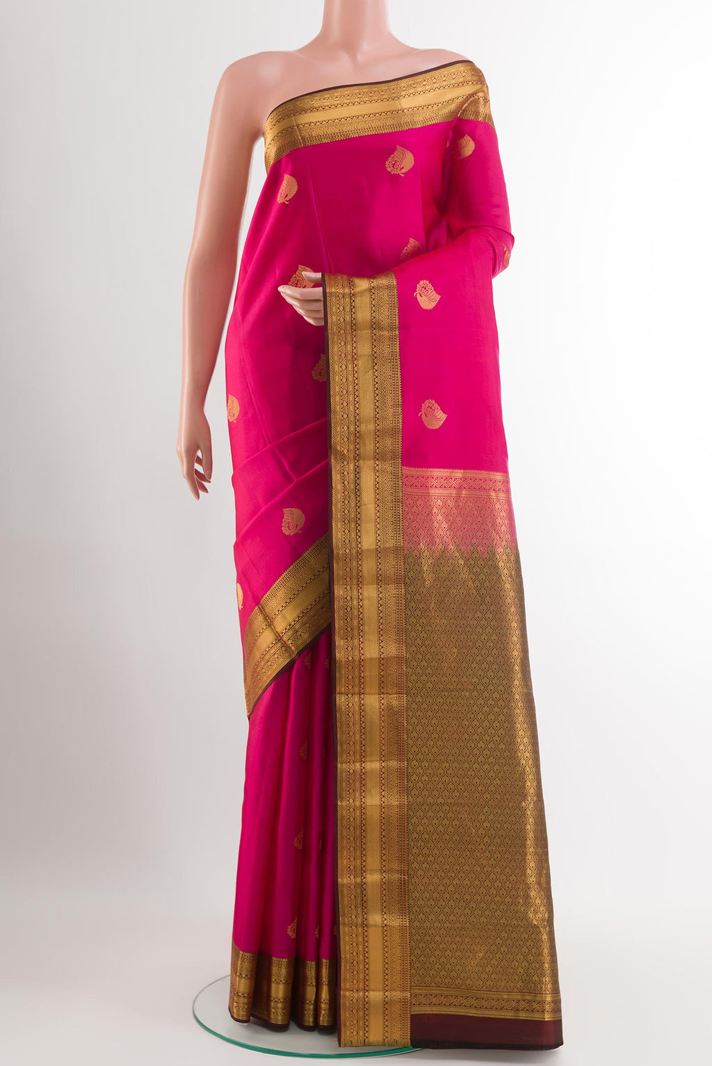 Pink Kanchipuram Silk Saree with Zari Butta on the body and Zari Border.  displayed on a mannequin