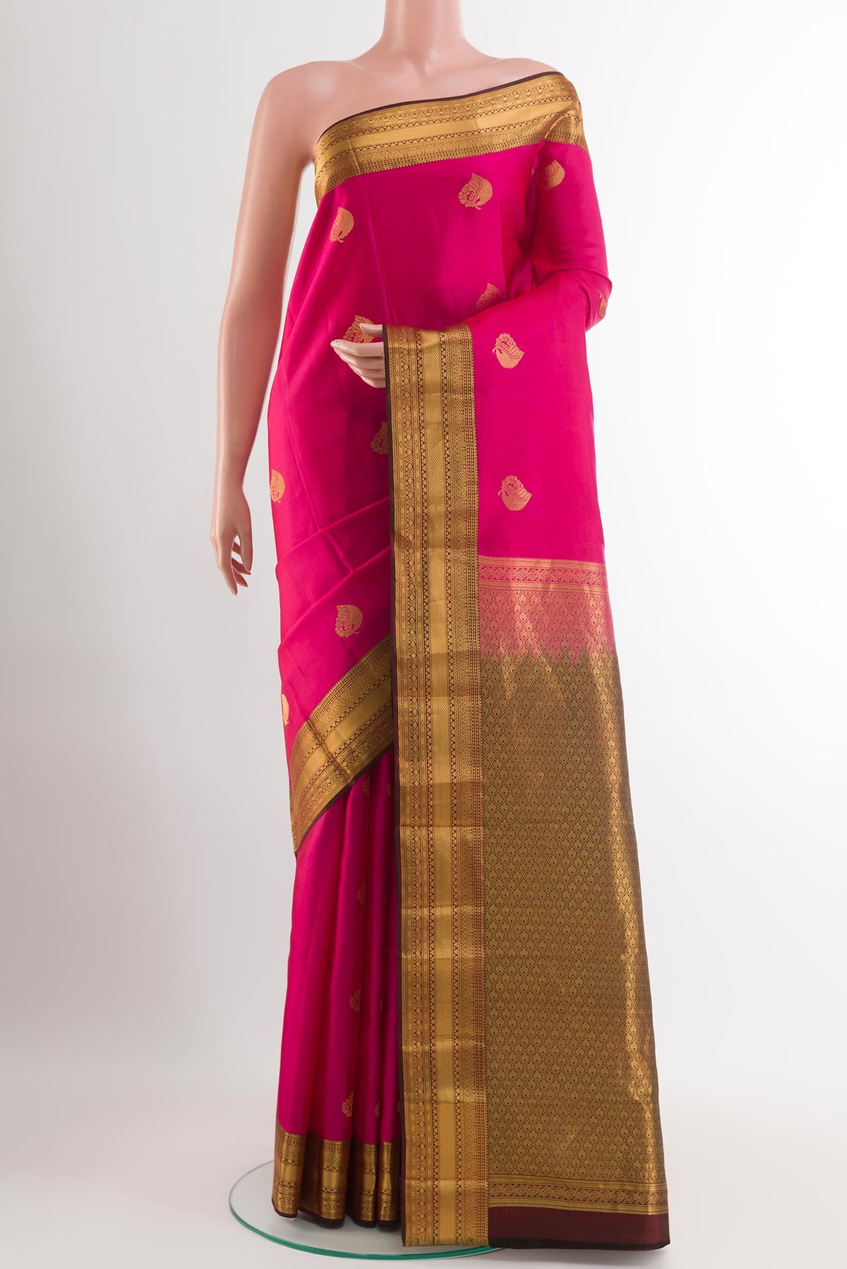 Pink Kanchipuram Silk Saree with Zari Butta on the body and Zari Border.  displayed on a mannequin
