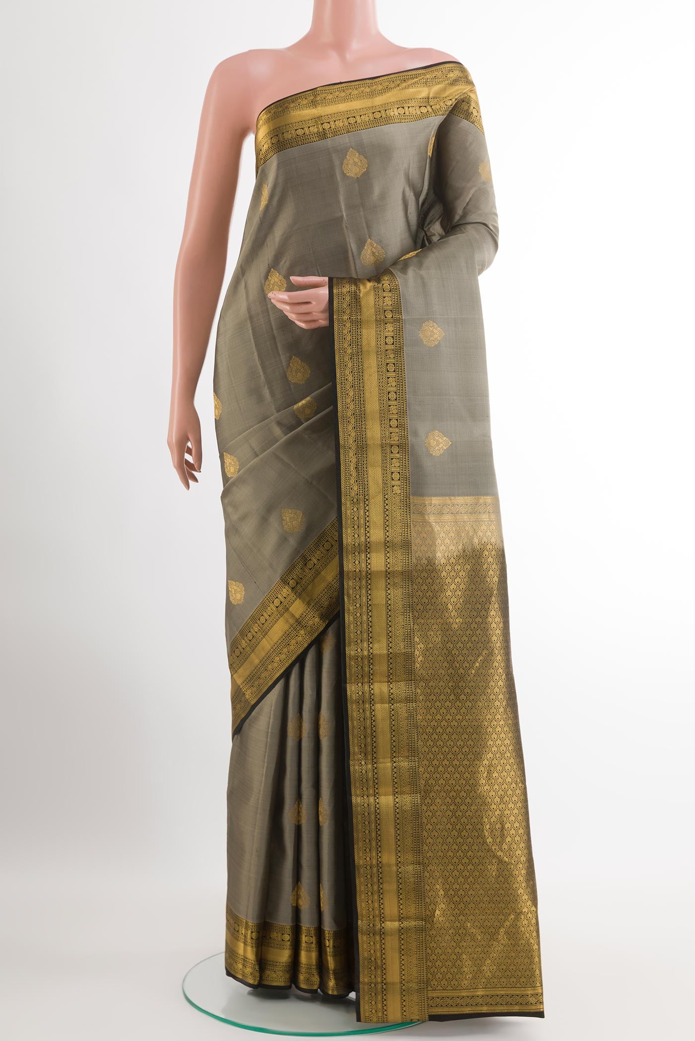 Grey Kanchipuram Silk Saree with Zari Butta on the body and Zari Border.  displayed on a mannequin