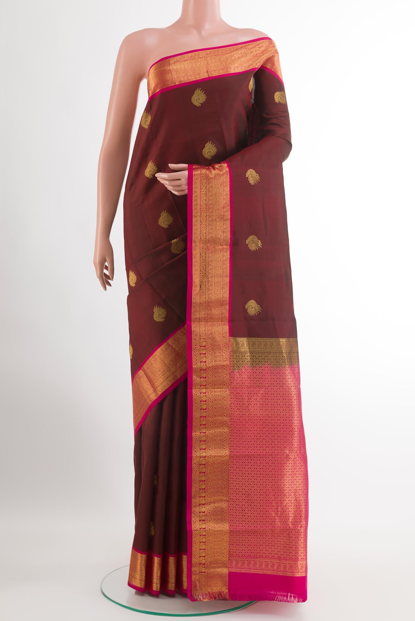 Maroon Kanchipuram Silk Saree with Zari Butta on the body and Zari Border.  displayed on a mannequin