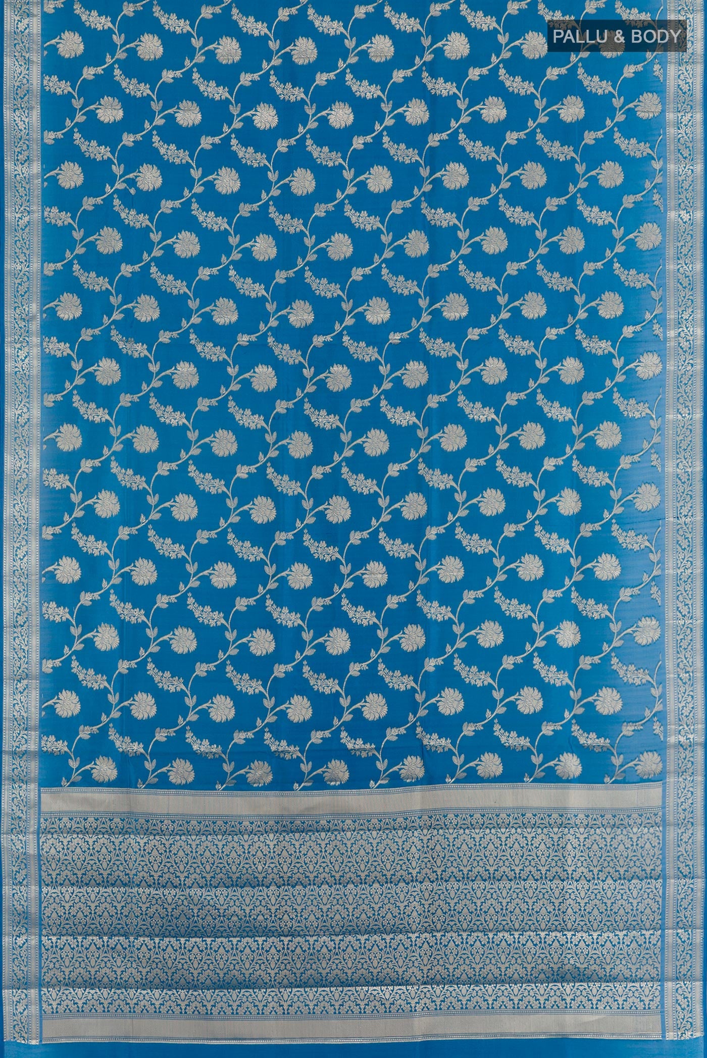 Flat view of Blue Banarasi Tussar Silk Saree with Zari Brocade on the body and Zari Border. 