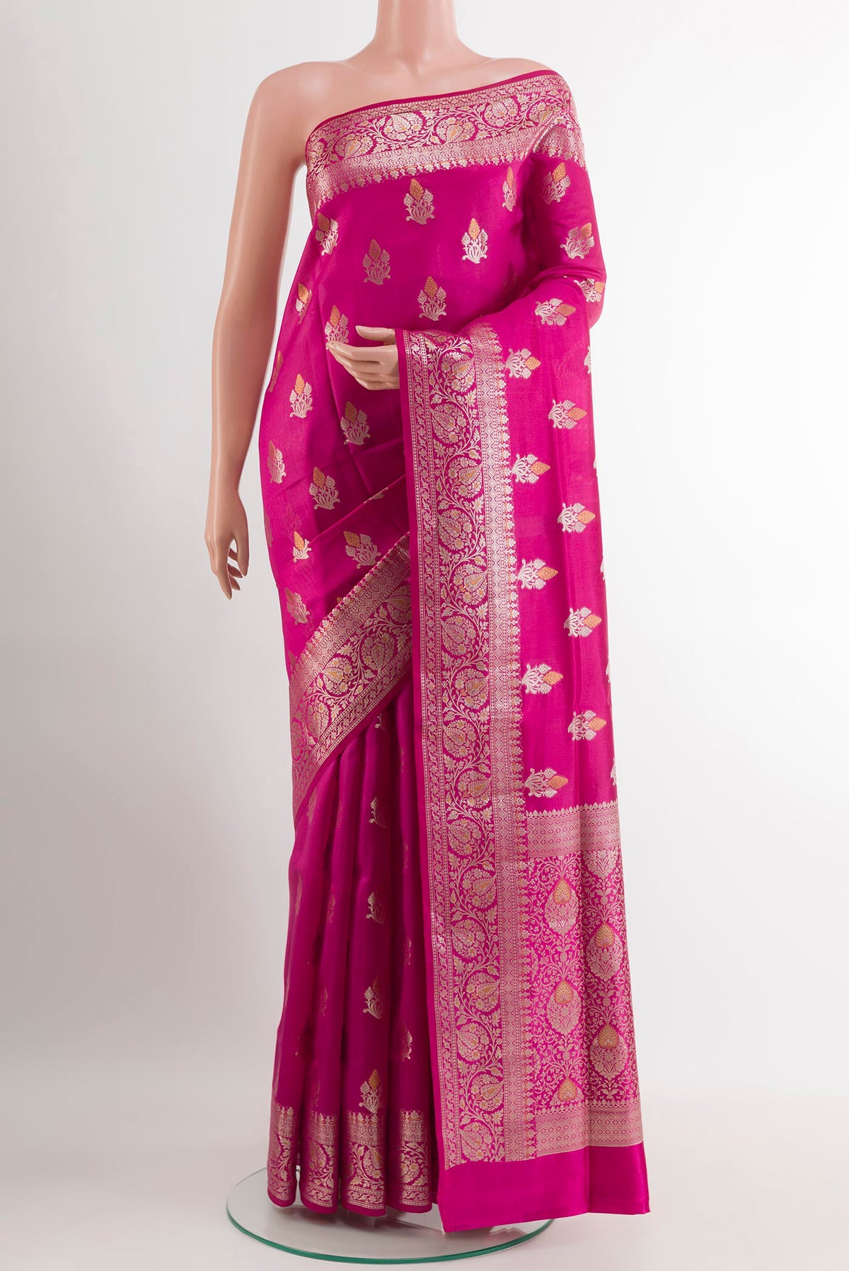 Rani Pink Tussar Silk Saree with Zari Butta on the body and Zari Border.  displayed on a mannequin