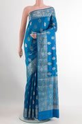 Blue Tussar Silk Saree with Zari Butta on the body and Zari Border.  displayed on a mannequin