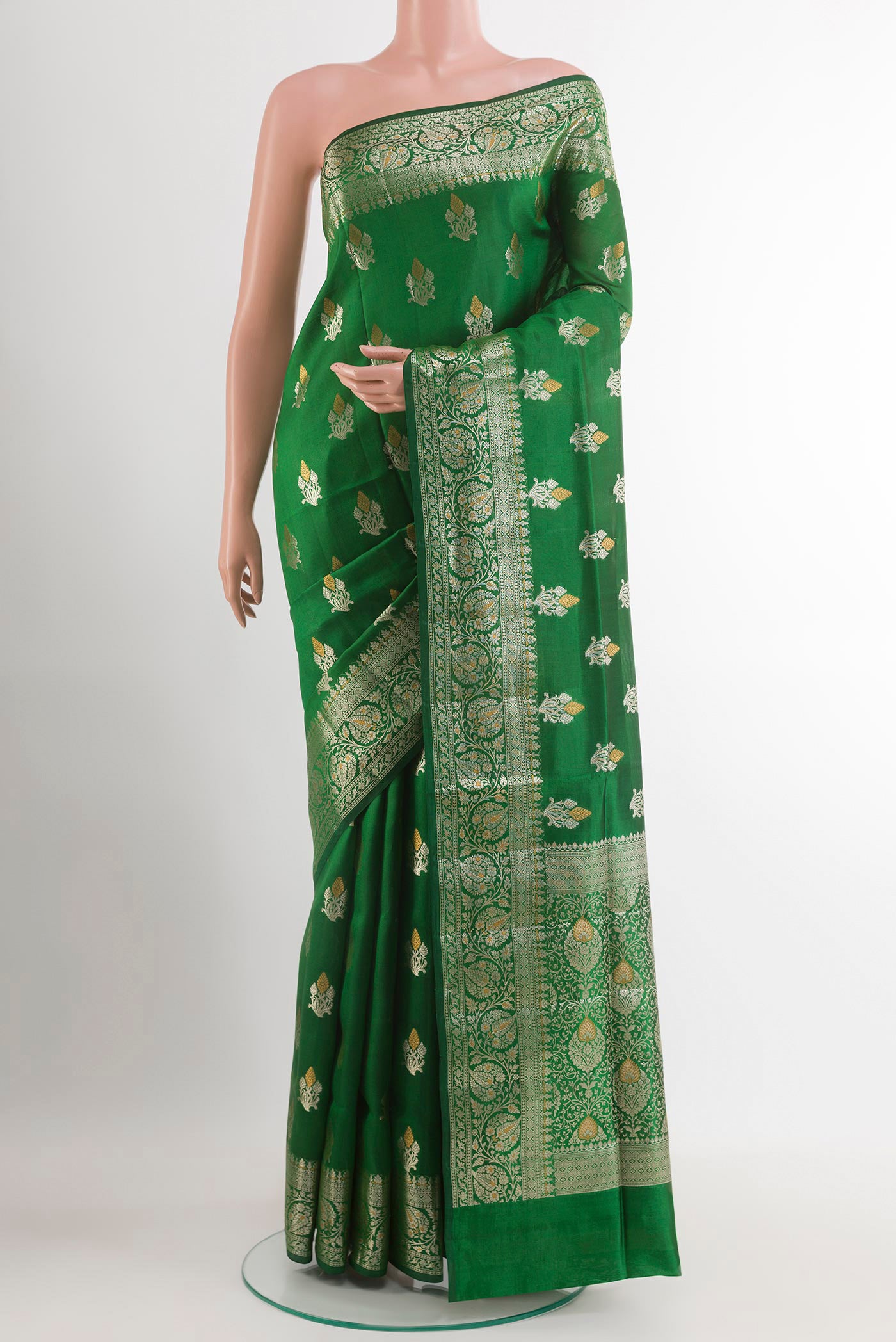 Green Tussar Silk Saree with Zari Butta on the body and Zari Border.  displayed on a mannequin