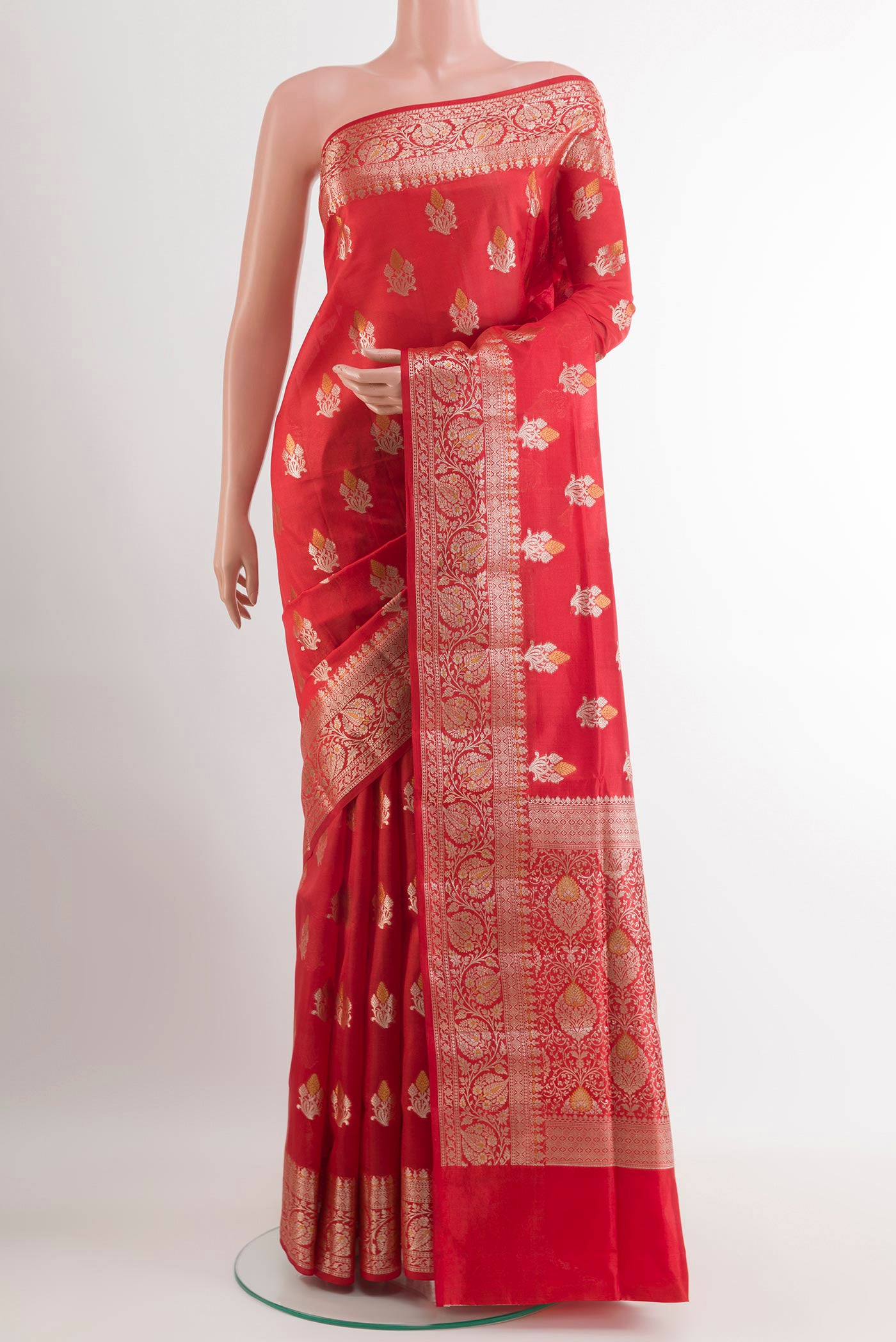 Red Tussar Silk Saree with Zari Butta on the body and Zari Border.  displayed on a mannequin