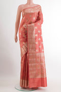 Peach Tussar Silk Saree with Zari Butta on the body and Zari Border.  displayed on a mannequin