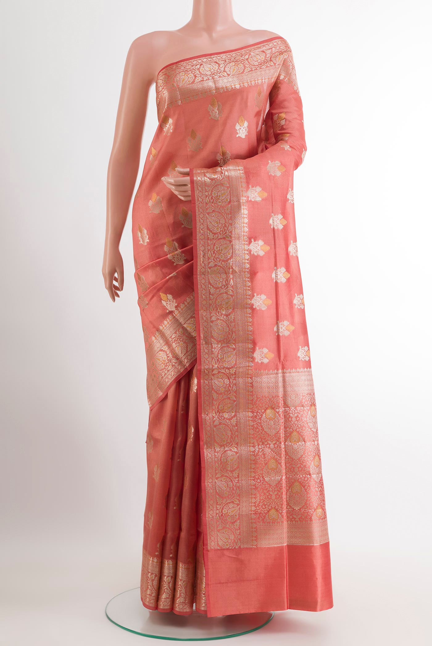 Peach Tussar Silk Saree with Zari Butta on the body and Zari Border.  displayed on a mannequin