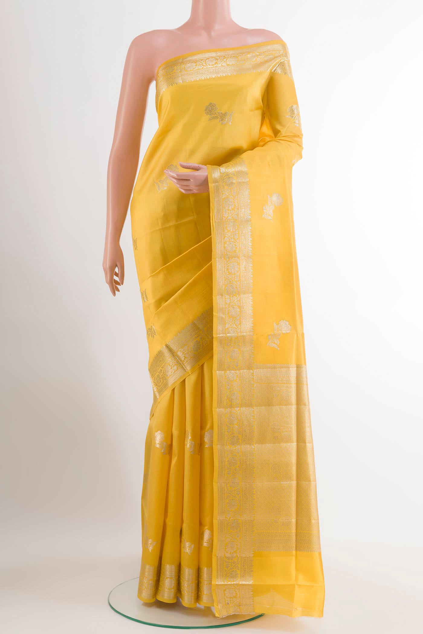 Yellow Tussar Silk Saree with Zari Butta on the body and Zari Border.  displayed on a mannequin