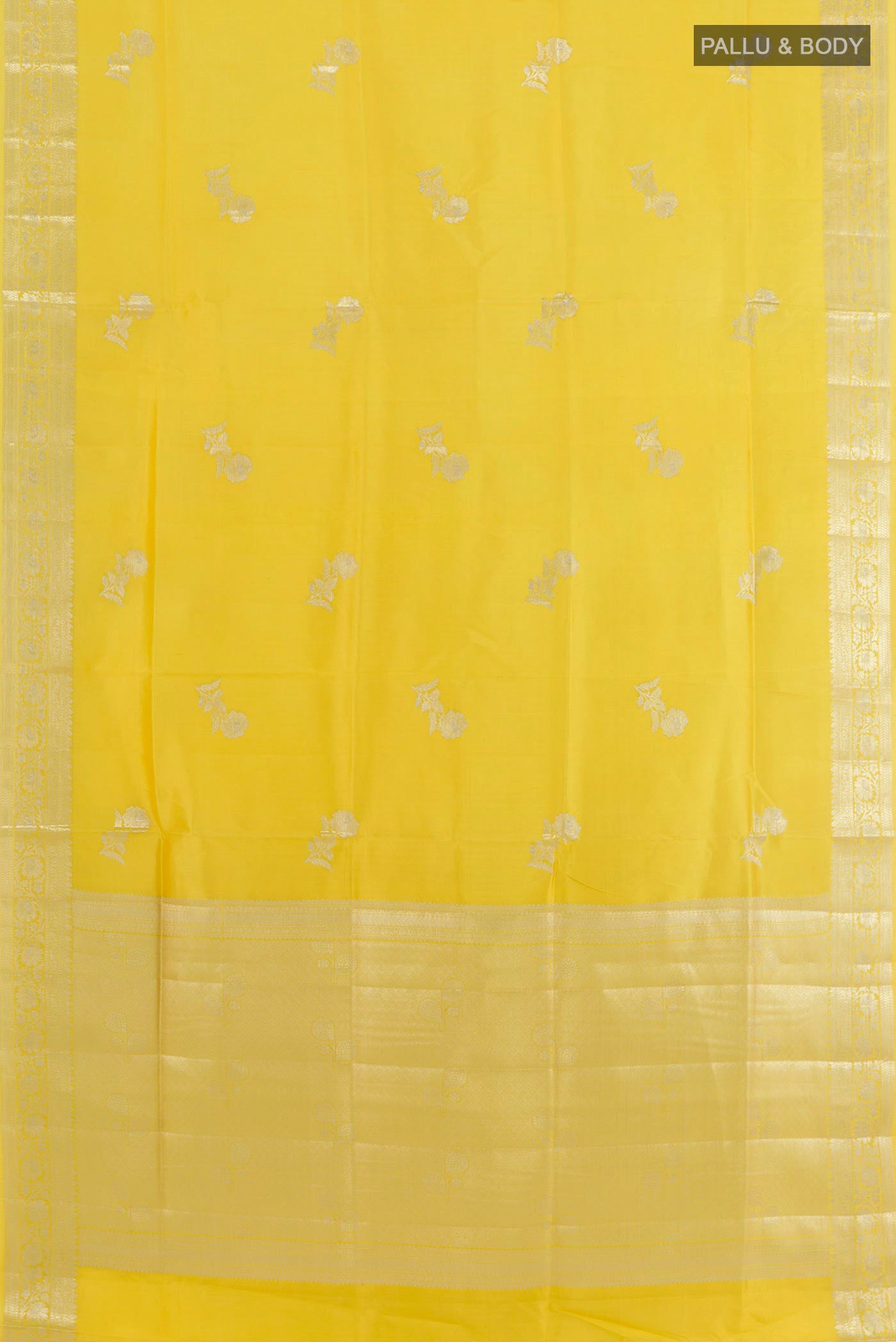 Flat view of Yellow Tussar Silk Saree with Zari Butta on the body and Zari Border. 