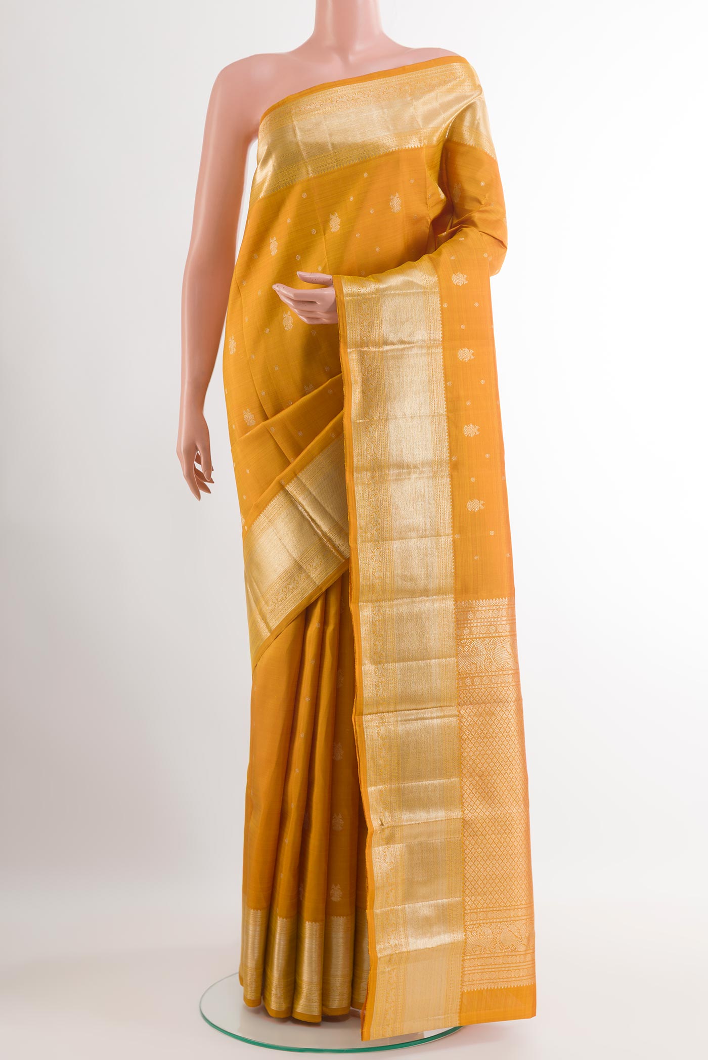 Yellow Kanjivaram Silk Saree with Zari Butta on the body and Zari Border.  displayed on a mannequin