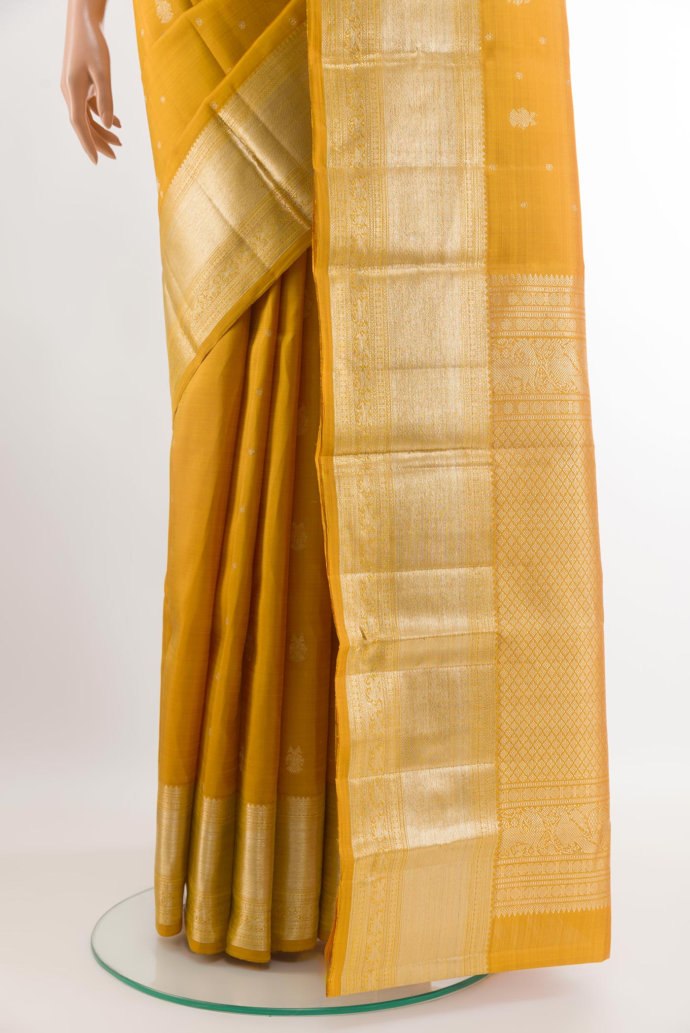Pleats and pallu of Yellow Kanjivaram Silk Saree with Zari Butta on the body and Zari Border. 