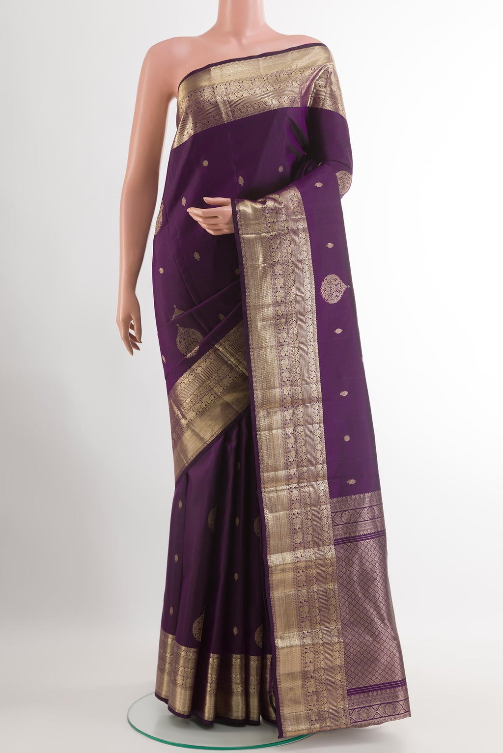 Purple Kanjivaram Silk Saree with Zari Butta on the body and Zari Border.  displayed on a mannequin