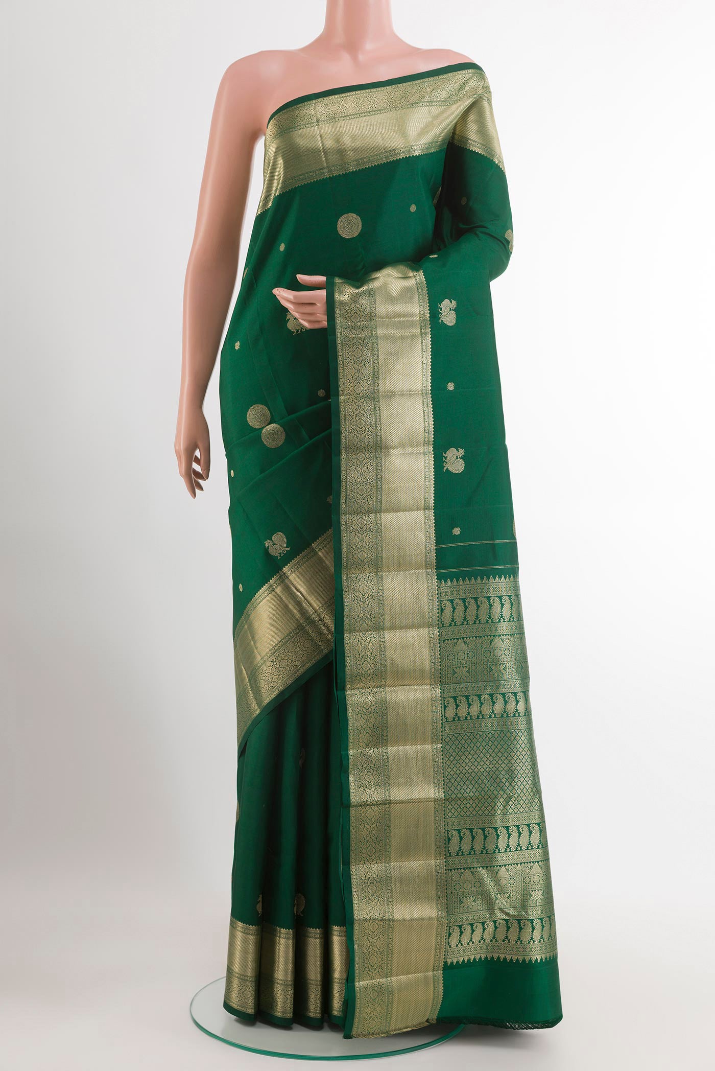 Green Kanjivaram Silk Saree with Zari Butta on the body and Zari Border.  displayed on a mannequin