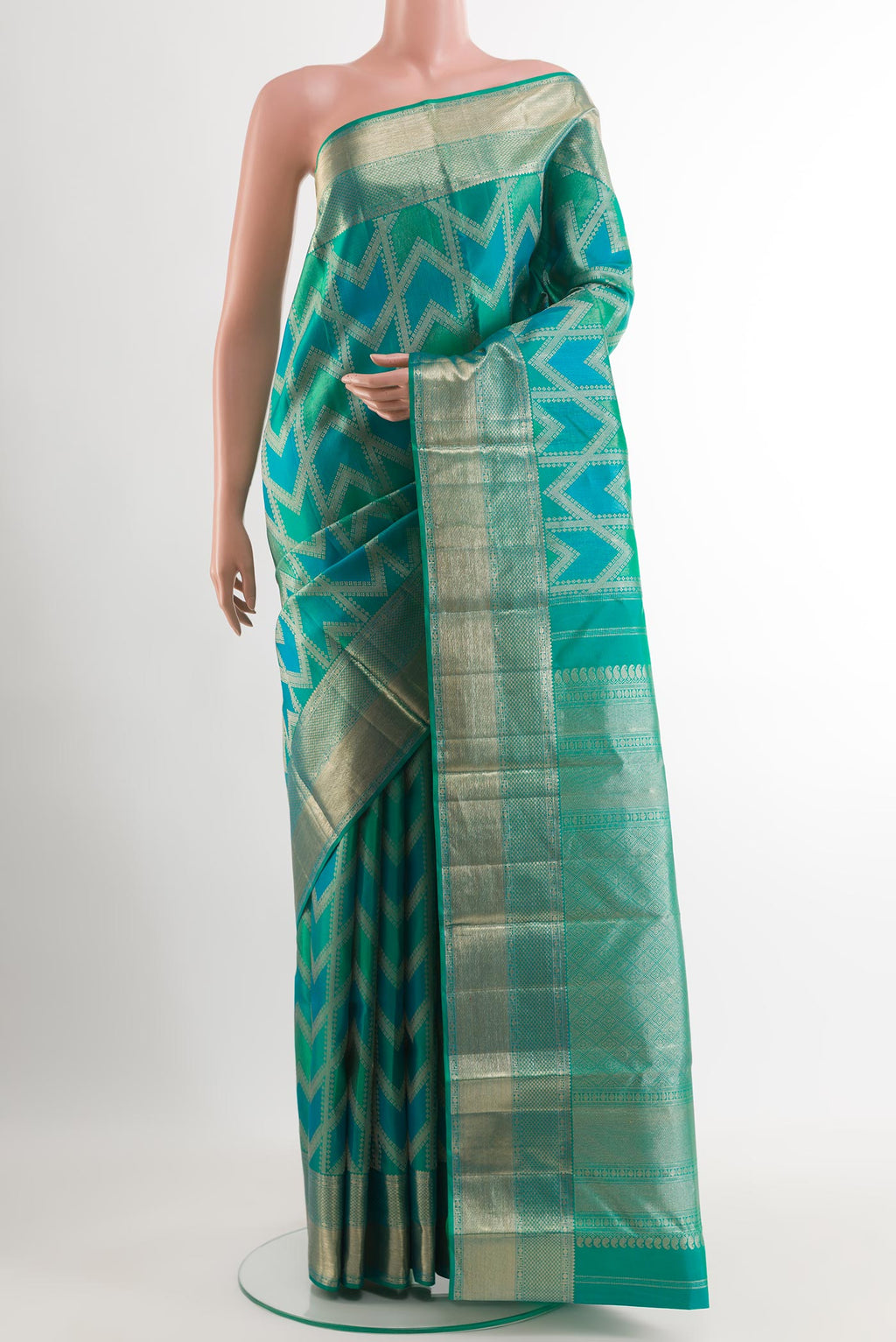 Green Kanjivaram Silk Saree with Zari Brocade on the body and Zari Border.  displayed on a mannequin