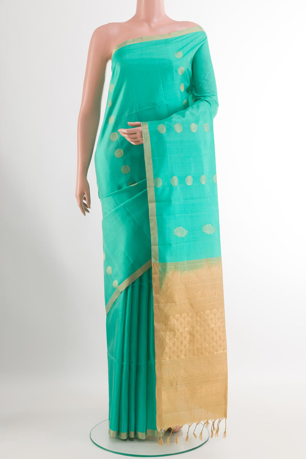 Turquoise Soft Silk Saree with Zari Butta on the body and Zari Border.  displayed on a mannequin