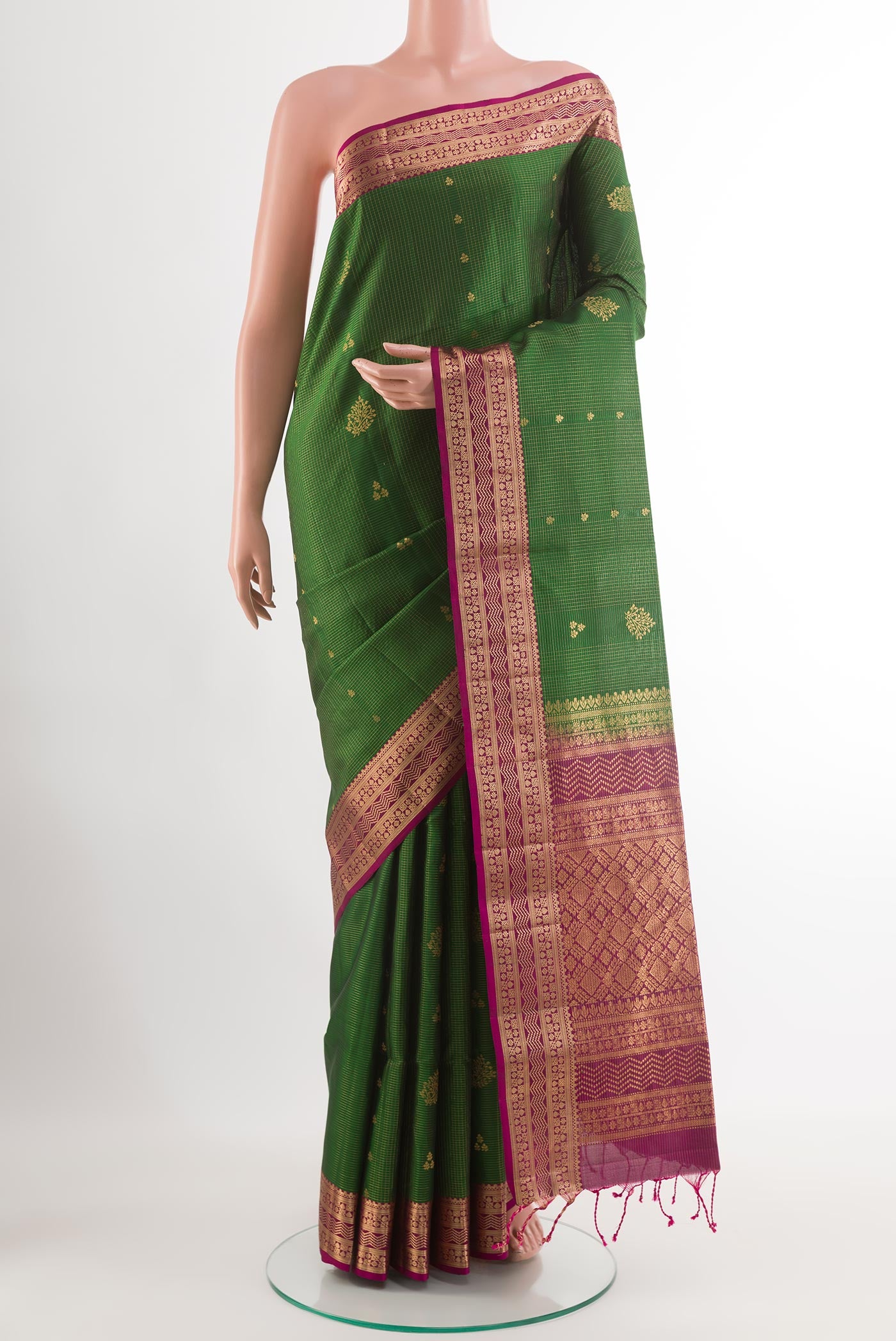 Green Soft Silk Saree with Checked design on the body and Zari Border.  displayed on a mannequin