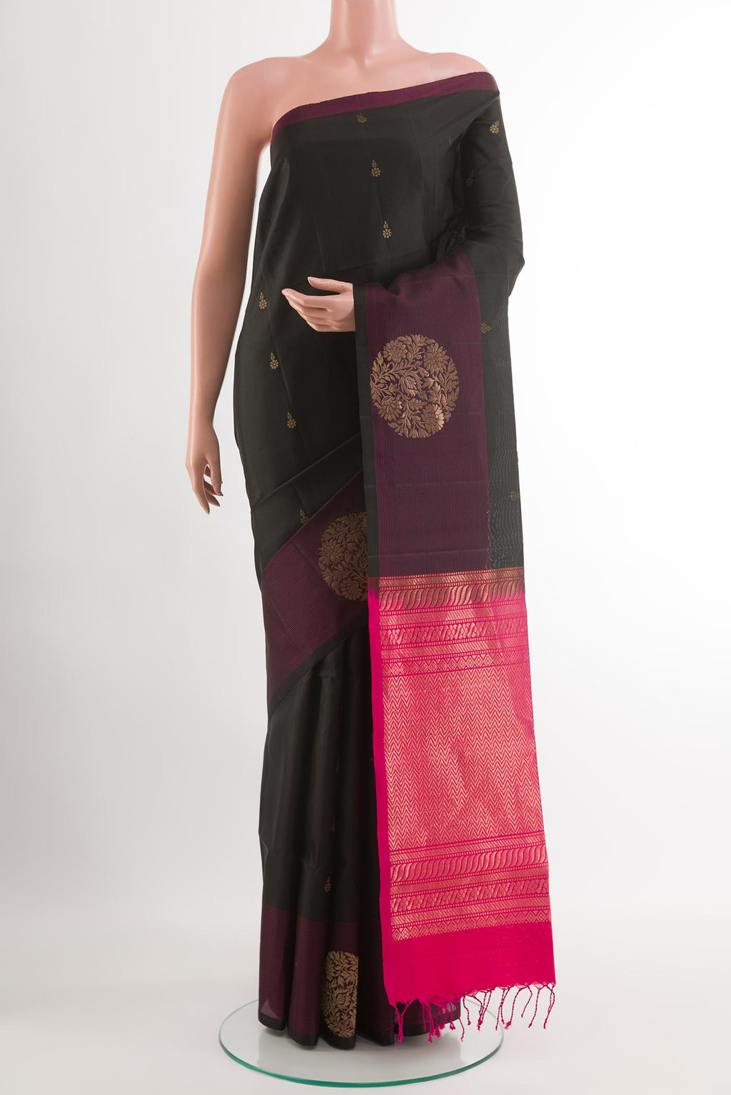 Black Soft Silk Saree with Zari Butta on the body and Zari Border.  displayed on a mannequin