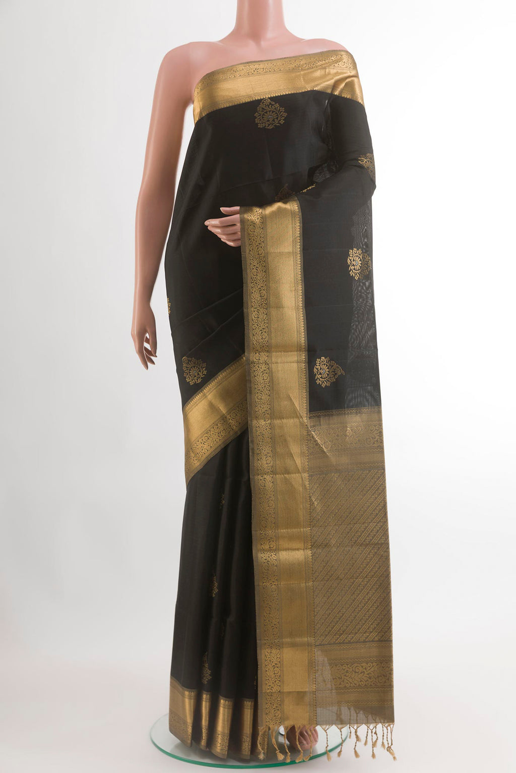 Black Soft Silk Saree with Zari Butta on the body and Zari Border.  displayed on a mannequin