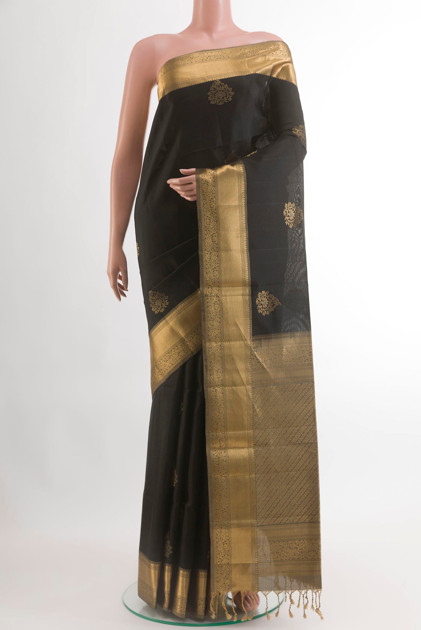 Black Soft Silk Saree with Zari Butta on the body and Zari Border.  displayed on a mannequin