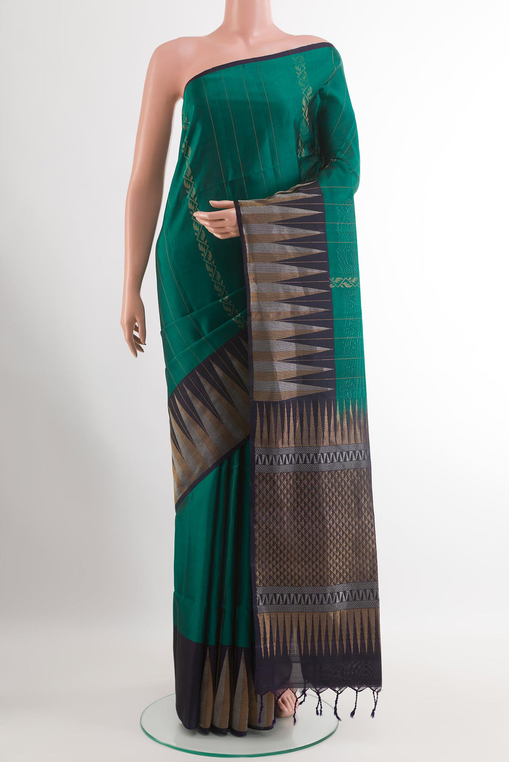 Bottle Green Soft Silk Saree with Zari Butta on the body and Zari Border.  displayed on a mannequin