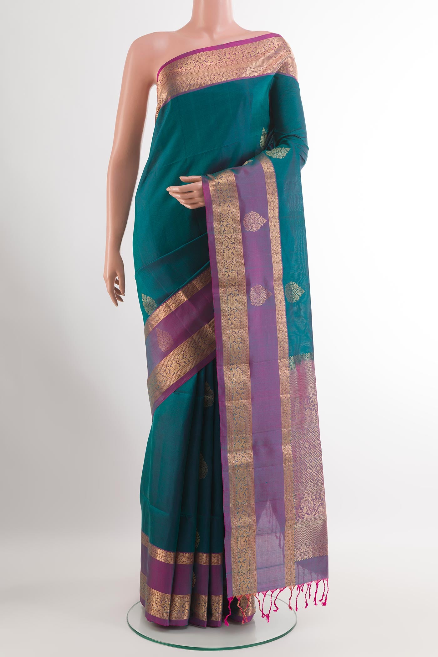 Peacock Blue Soft Silk Saree with Zari Butta on the body and Zari Border.  displayed on a mannequin