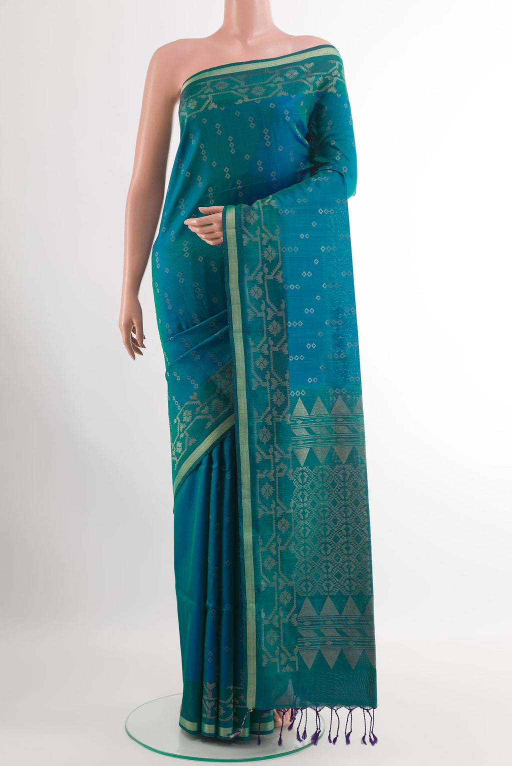 Peacock Blue Soft Silk Saree with Zari Butta on the body and Zari Border.  displayed on a mannequin