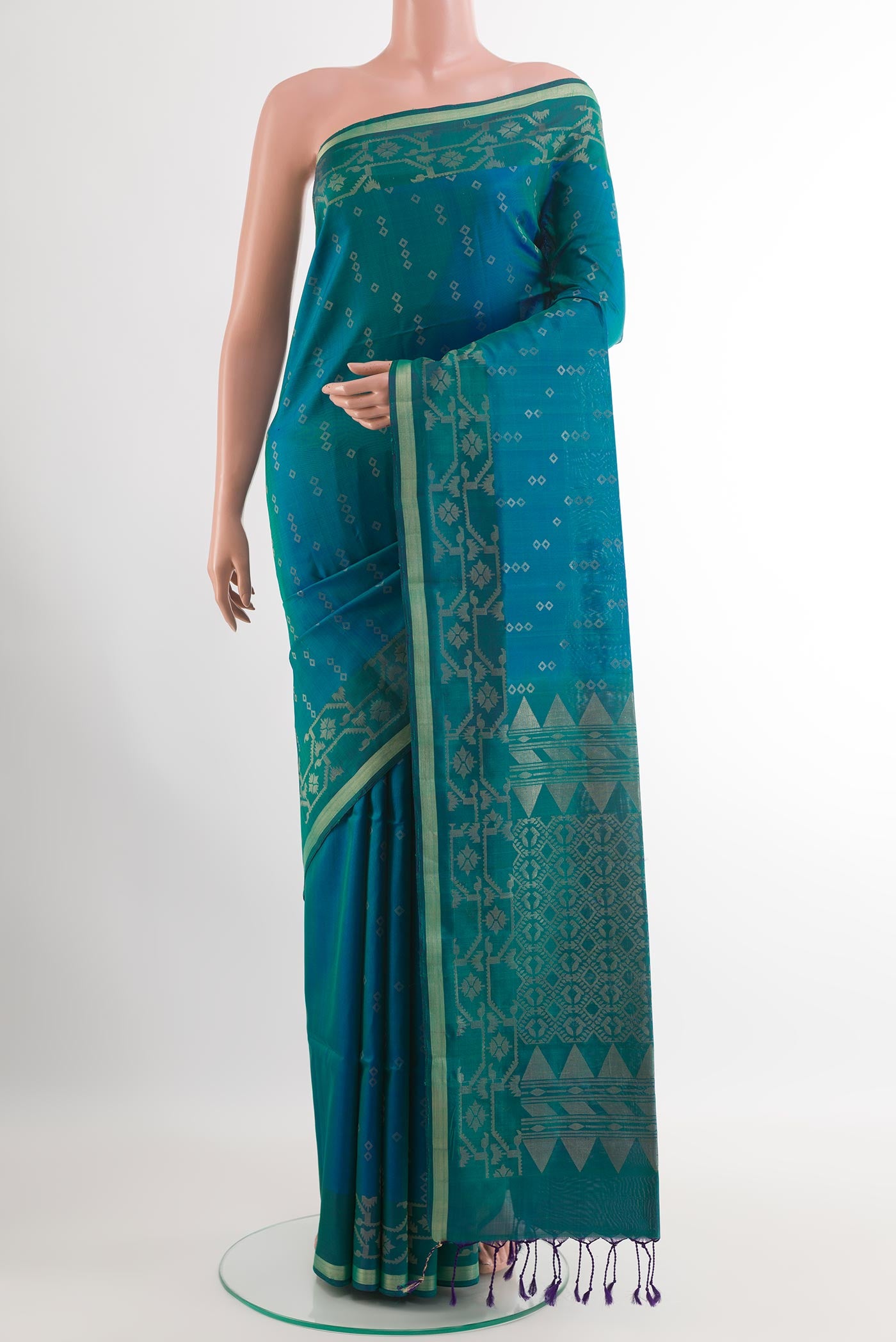 Peacock Blue Soft Silk Saree with Zari Butta on the body and Zari Border.  displayed on a mannequin