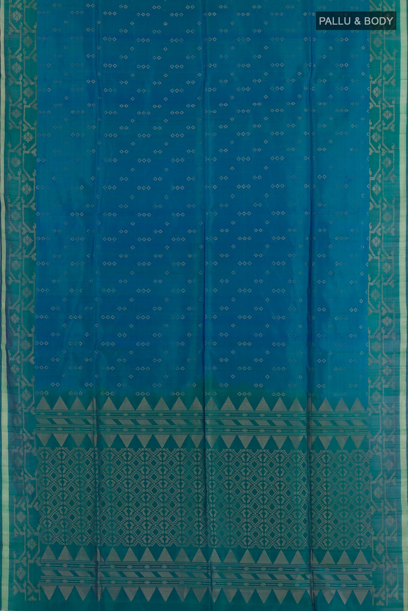 Flat view of Peacock Blue Soft Silk Saree with Zari Butta on the body and Zari Border. 