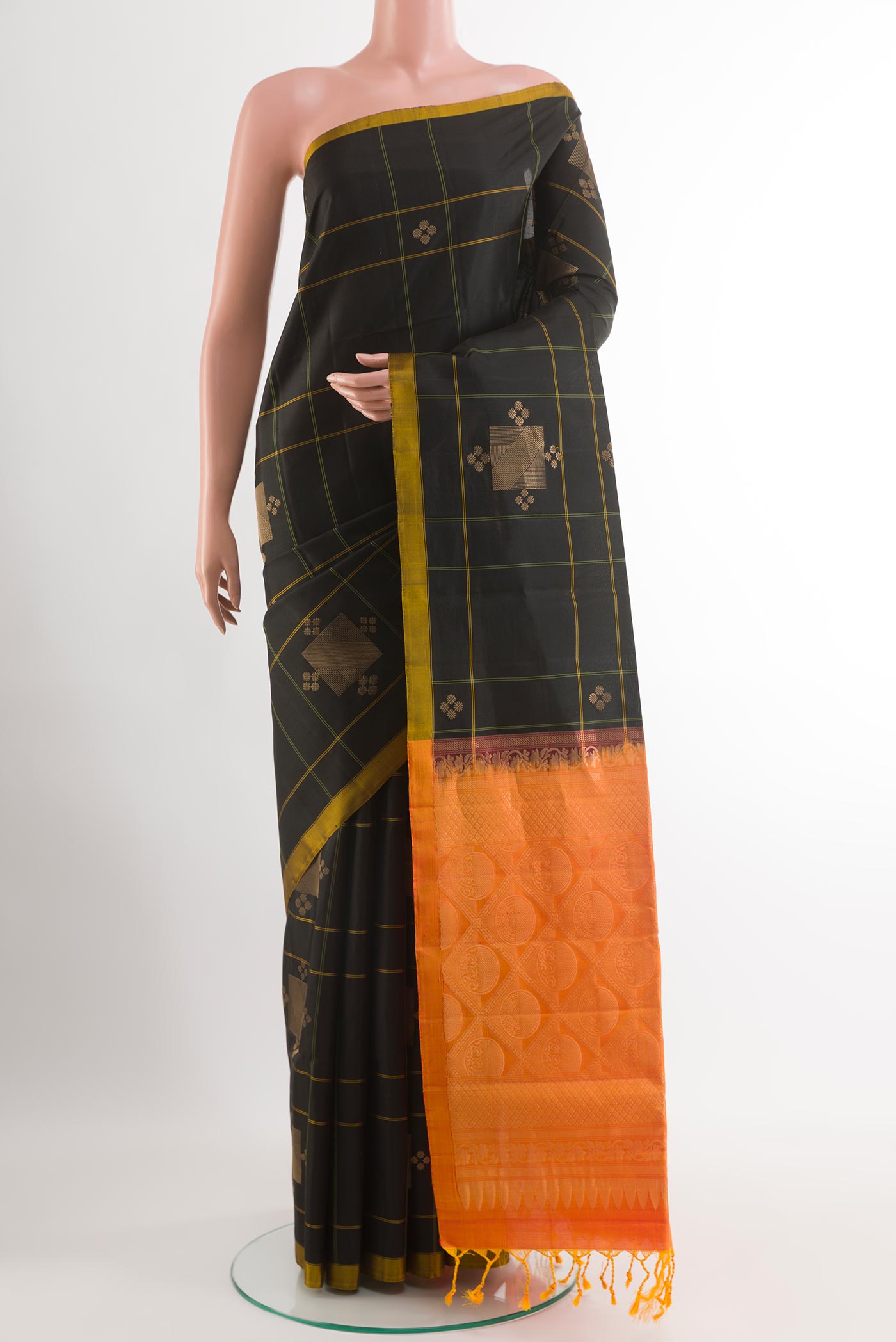 Black Soft Silk Saree with Zari Butta on the body and Zari Border.  displayed on a mannequin
