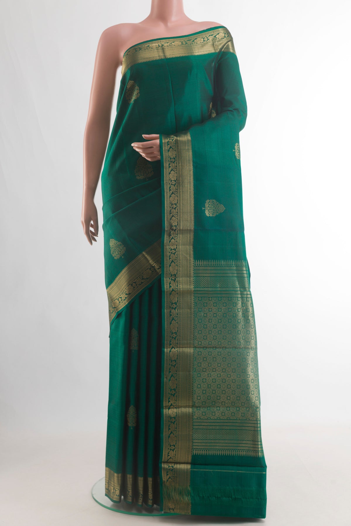 Pure Silk Green Kanchipuram Saree with Zari Butta on the body and Zari Border.  displayed on a mannequin