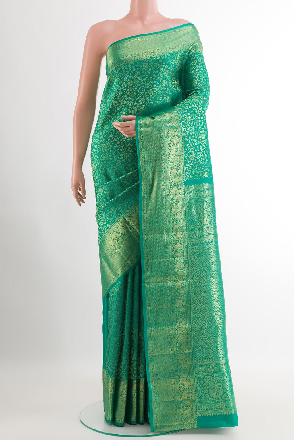 Green Kanchipuram Silk Saree with Zari Brocade on the body and Zari Border.  displayed on a mannequin