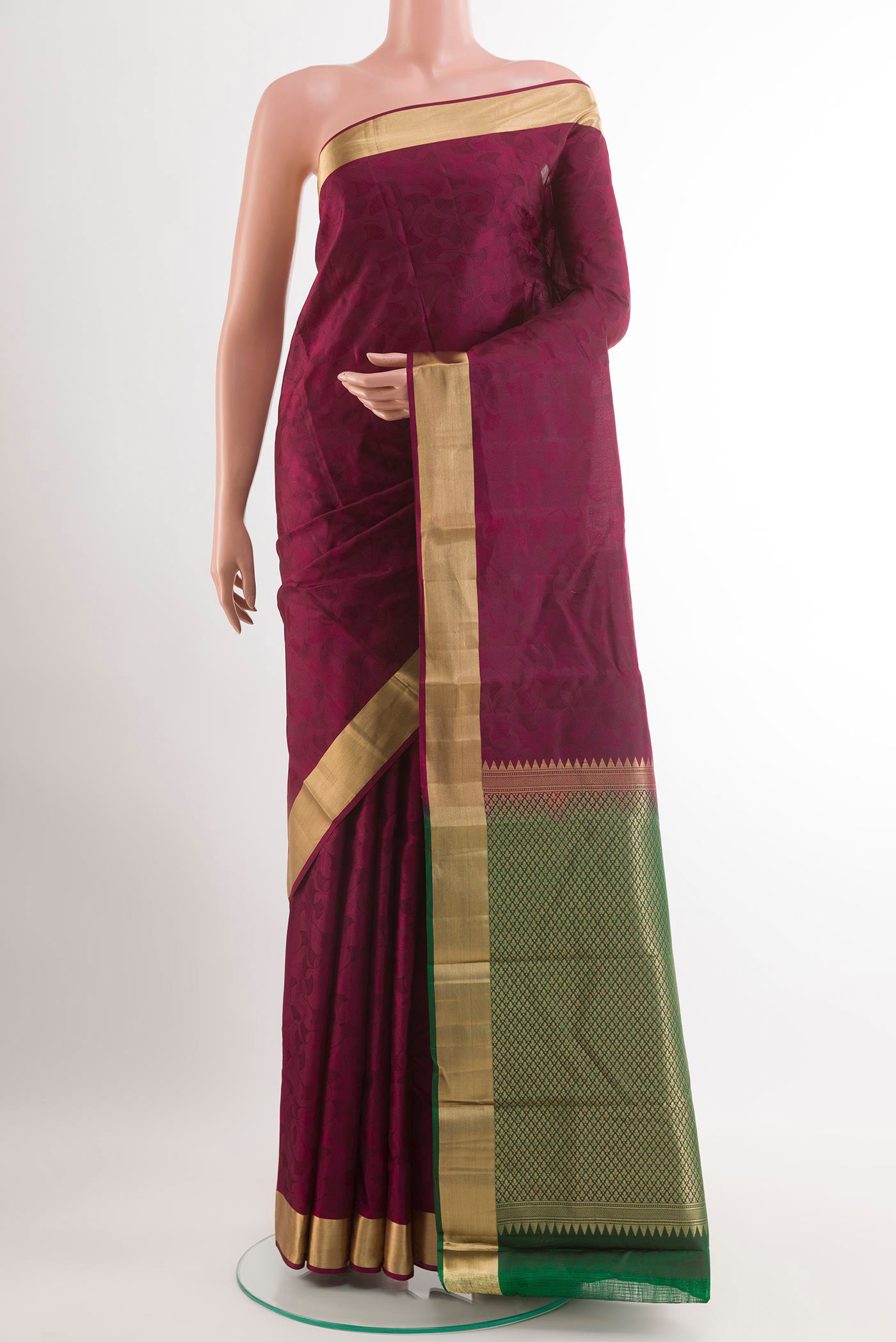 Purple Kanchipuram Silk Saree with Jacquard design on the body and Zari Border.  displayed on a mannequin