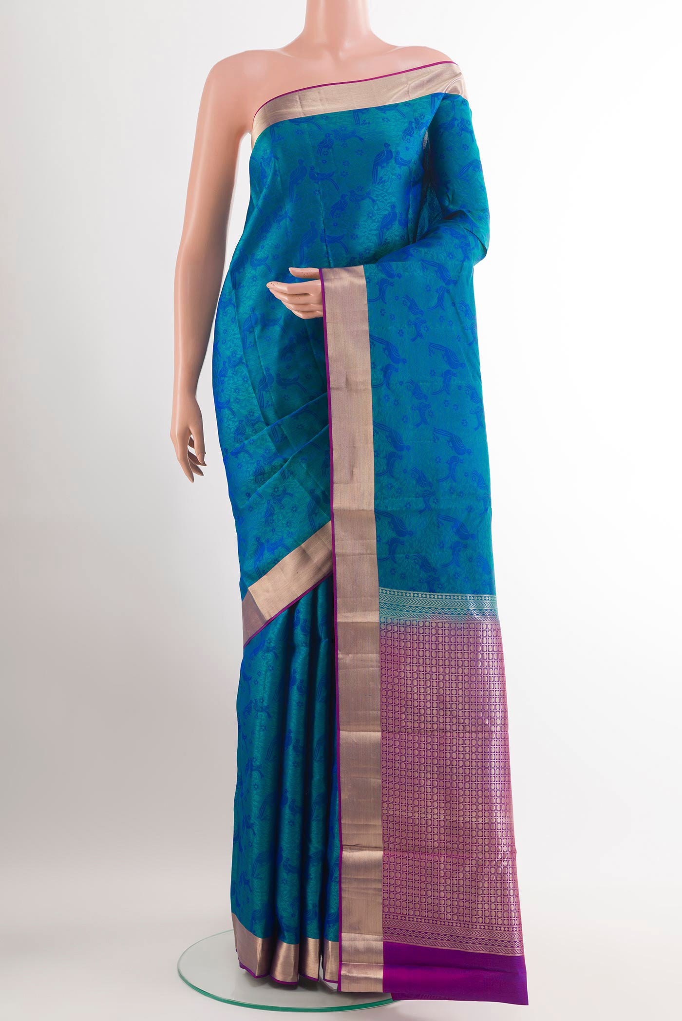 Peacock Blue Kanchipuram Silk Saree with Jacquard design on the body and Zari Border.  displayed on a mannequin