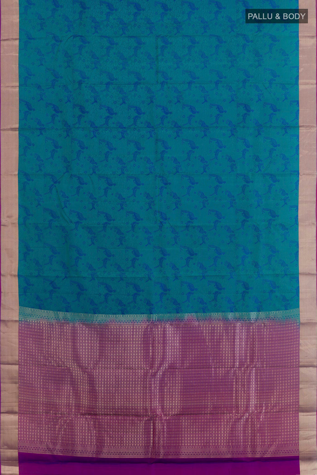 Flat view of Peacock Blue Kanchipuram Silk Saree with Jacquard design on the body and Zari Border. 