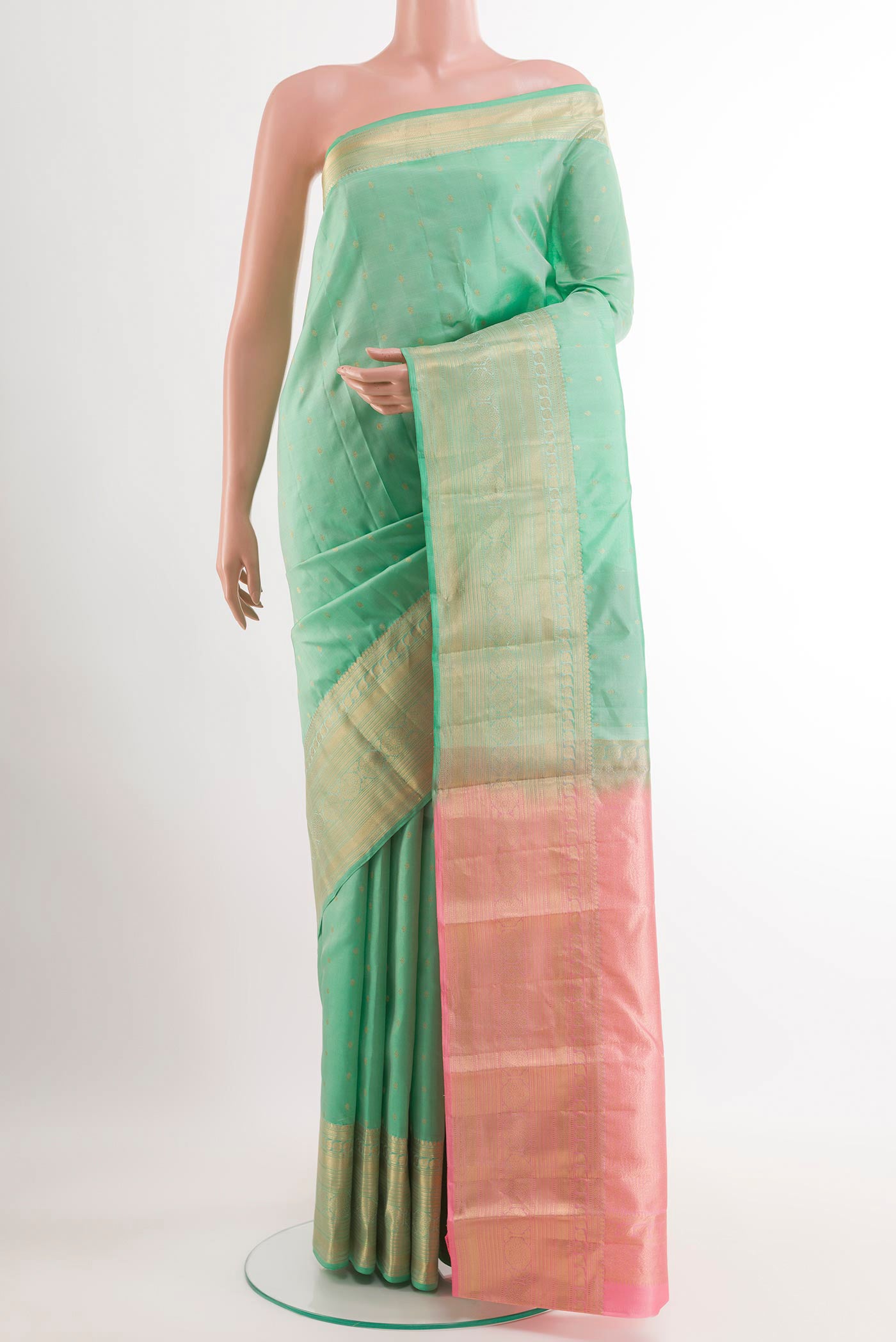 Sea Green Kanchipuram Silk Saree with Zari Butta on the body and Zari Border.  displayed on a mannequin