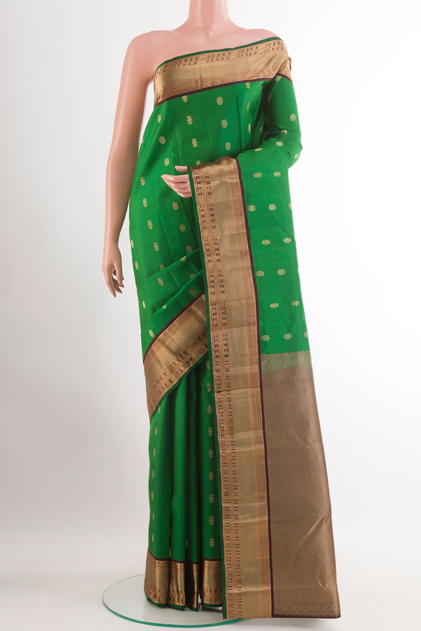 Green Kanjivaram Silk Saree with Zari Brocade on the body and Zari Border.  displayed on a mannequin