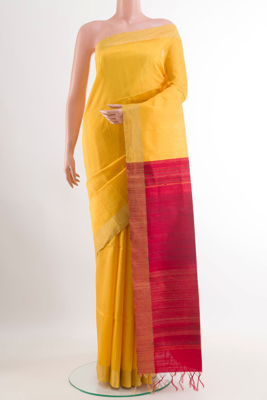 Yellow Raw Silk Saree with Plain Body and Zari Border.  displayed on a mannequin
