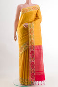 Yellow Raw Silk Saree with Zari Butta on the body and Zari Border.  displayed on a mannequin