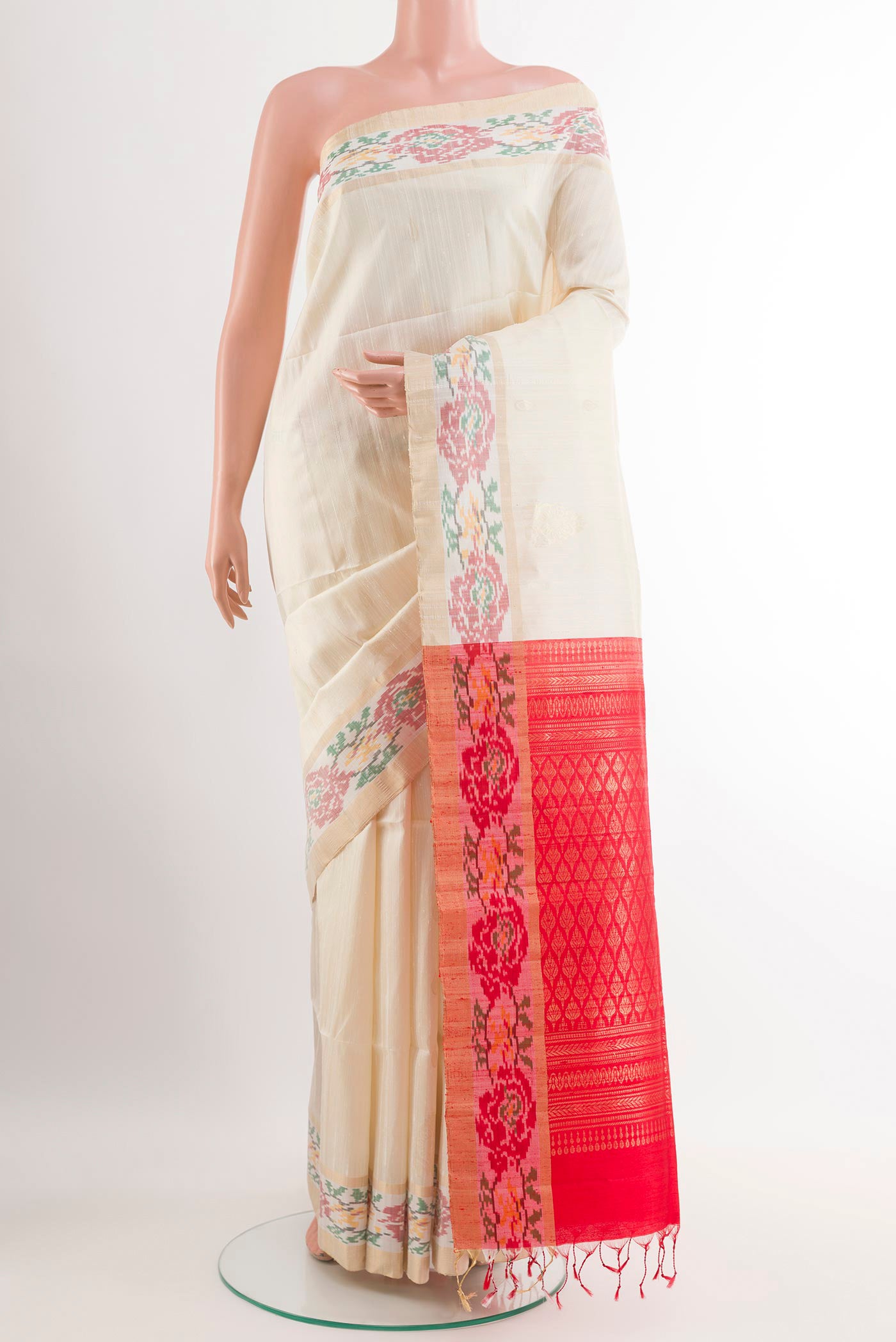 Off White Soft Silk Saree with Zari Butta on the body and Zari Border.  displayed on a mannequin