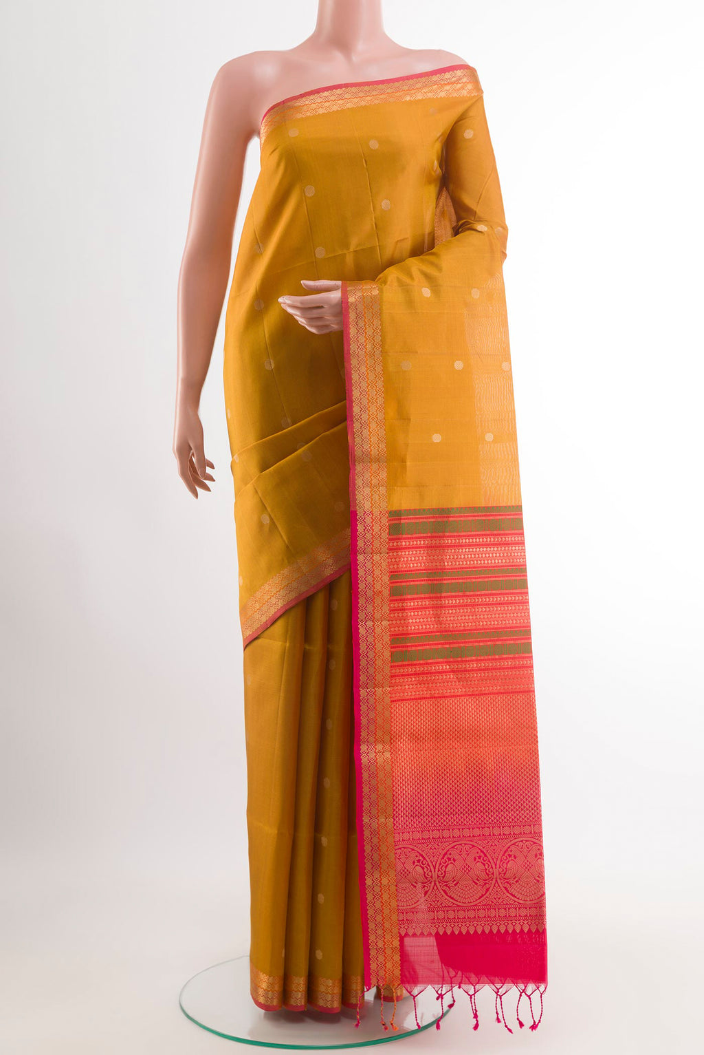 Yellow Soft Silk Saree with Zari Butta on the body and Zari Border.  displayed on a mannequin