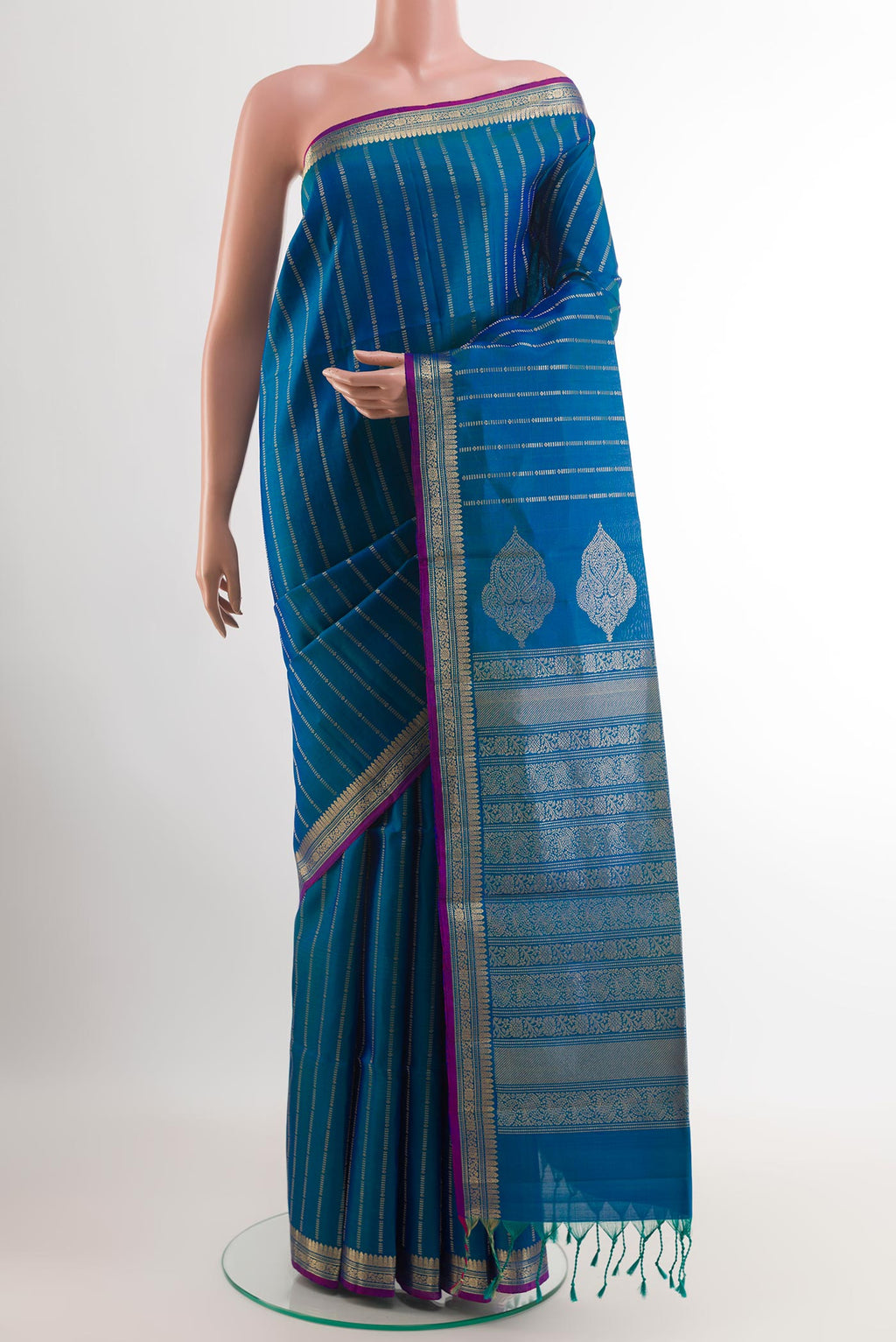 Peacock Blue Soft Silk Saree with Zari Butta on the body and Zari Border.  displayed on a mannequin