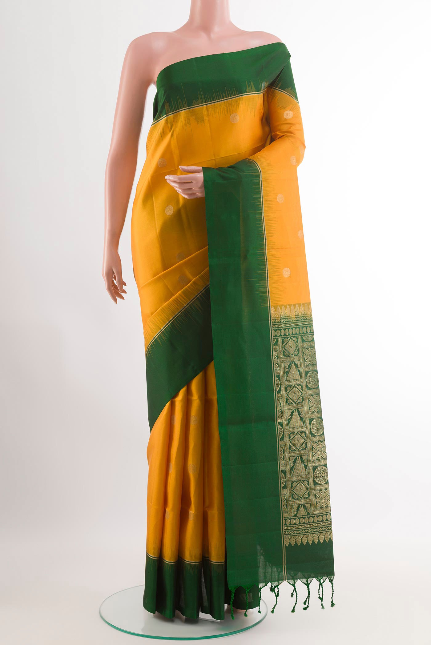 Yellow Soft Silk Saree with Zari Butta on the body and Zari Border.  displayed on a mannequin