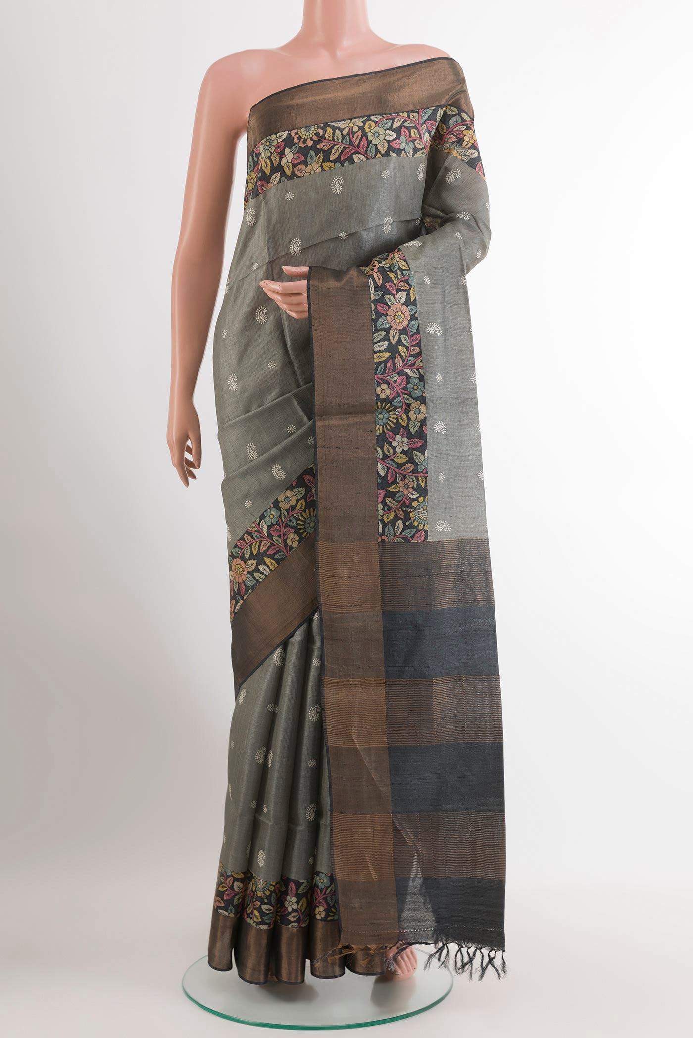 Grey Tussar Saree with Thread Butta on the body and Zari Border.  displayed on a mannequin
