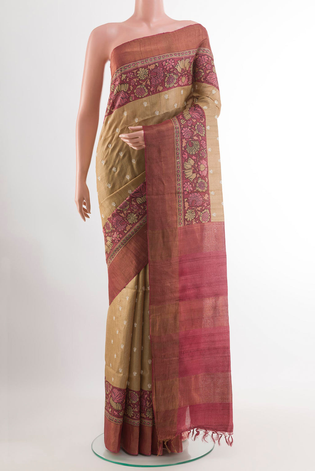 Beige Tussar Saree with Thread Butta on the body and Zari Border.  displayed on a mannequin