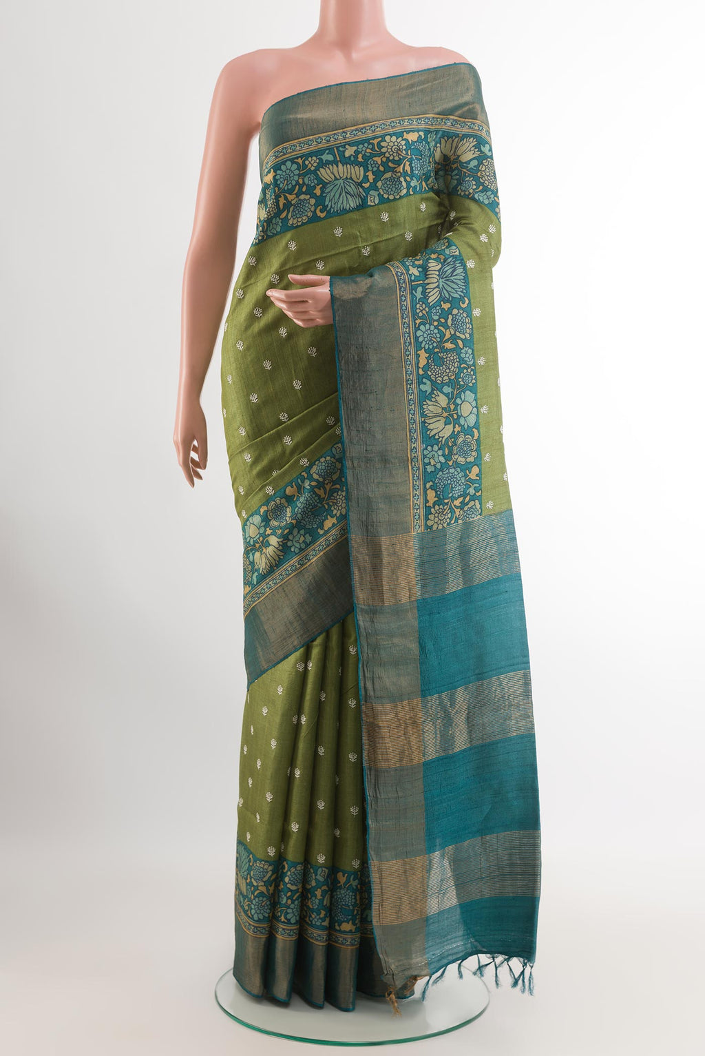 Green Tussar Saree with Thread Butta on the body and Zari Border.  displayed on a mannequin
