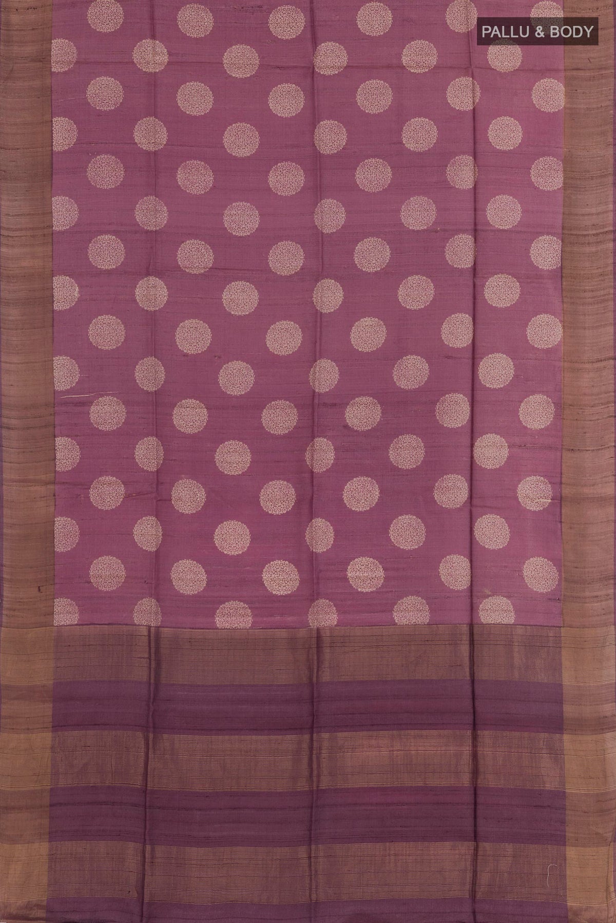 Flat view of Purple Tussar Saree with Printed design on the body and Zari Border. 