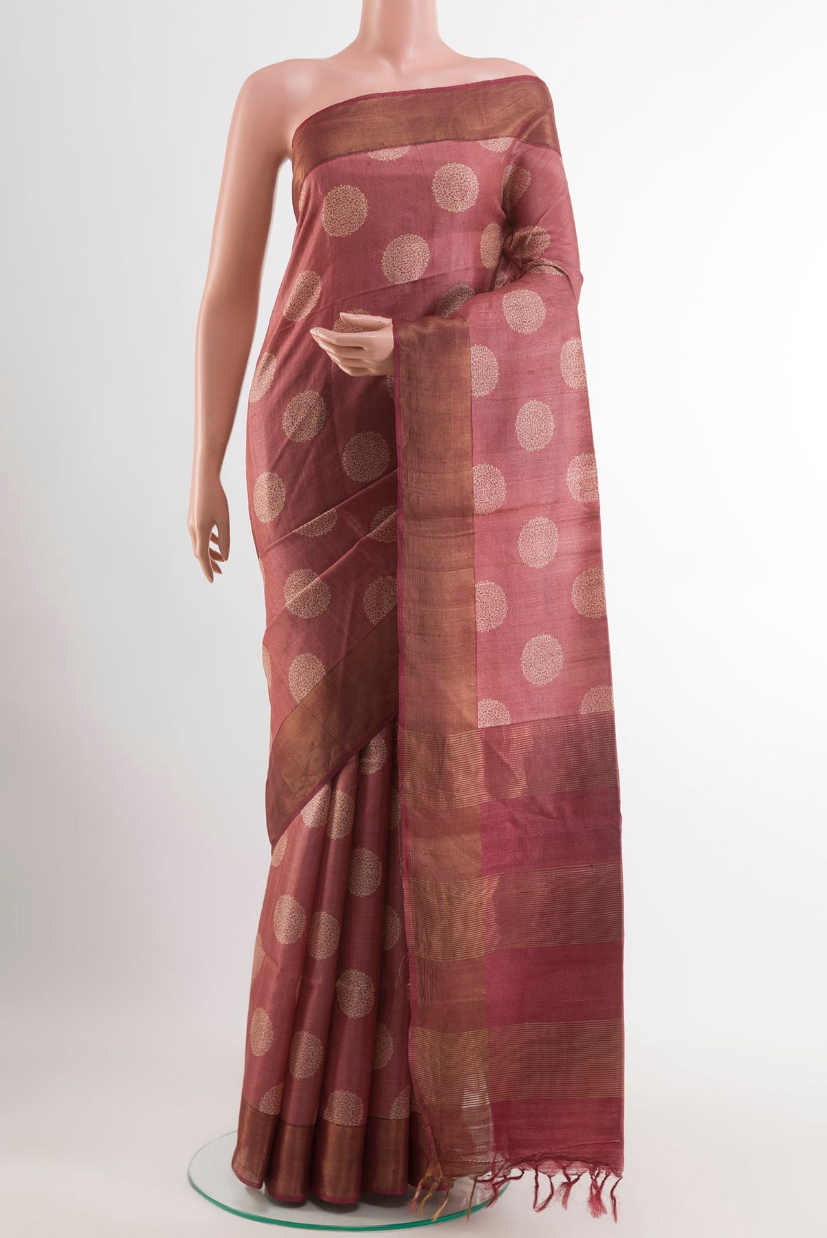 Maroon Tussar Saree with Printed design on the body and Zari Border.  displayed on a mannequin