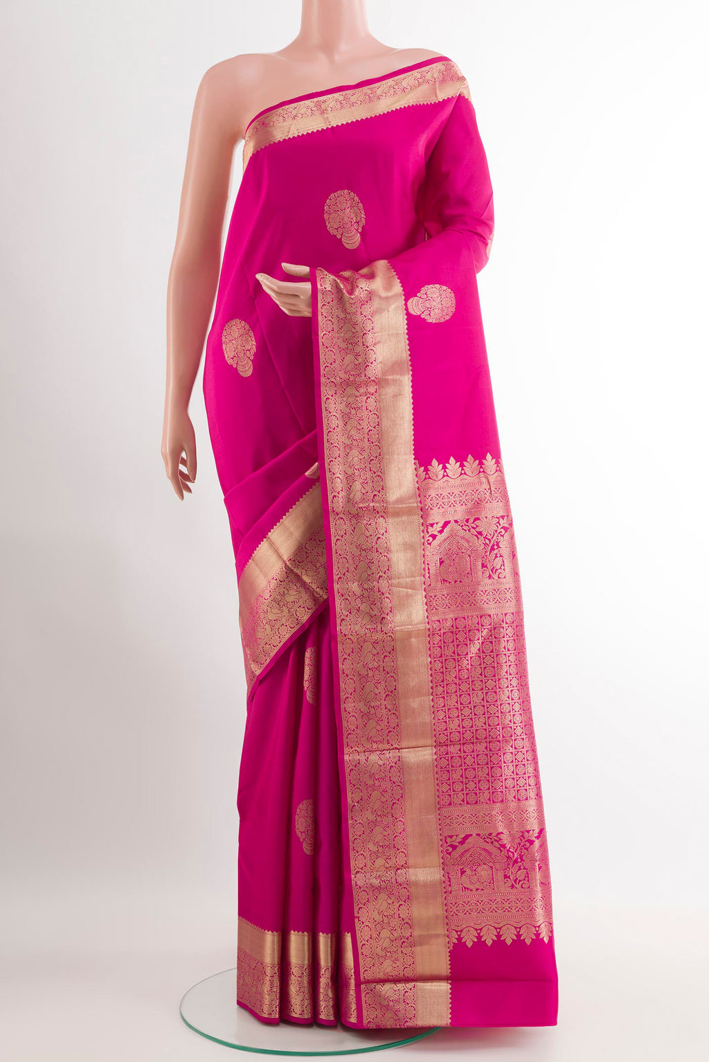 Rani Pink Kanchipuram Silk Saree with Zari Butta on the body and Zari Border.  displayed on a mannequin