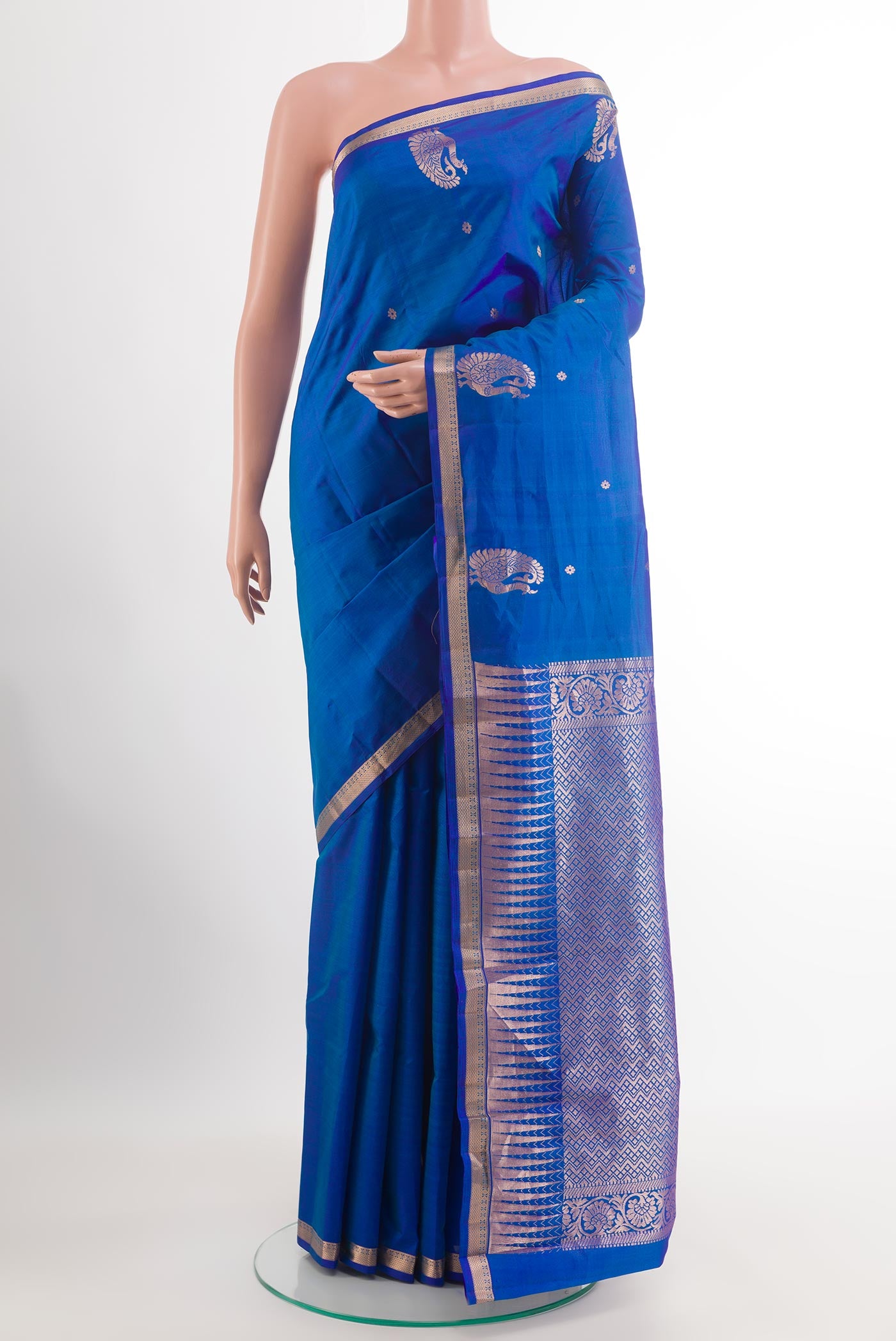 Blue Kanchipuram Silk Saree with Zari Butta on the body and Zari Border.  displayed on a mannequin