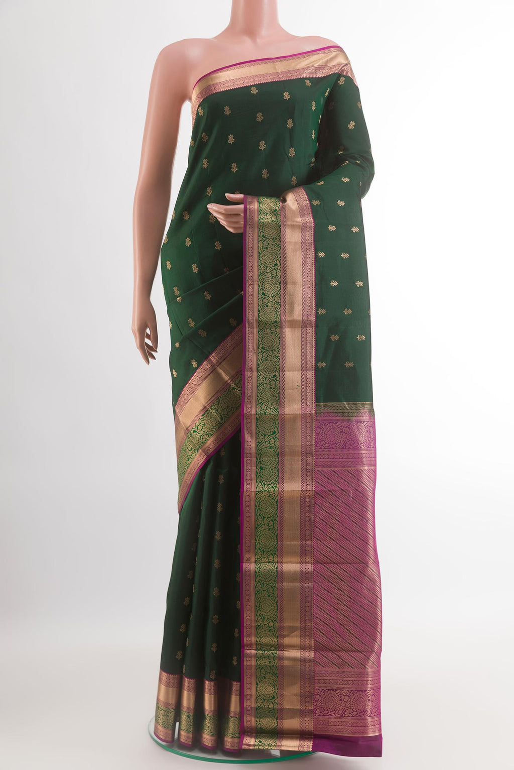 Bottle Green Kanchipuram Silk Saree with Zari Butta on the body and Zari Border.  displayed on a mannequin